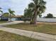 Newly painted ranch home with a long driveway and palm trees at 4701 Lodestone Dr, Tampa, FL 33615