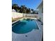 Kidney shaped pool with a concrete deck at 4701 Lodestone Dr, Tampa, FL 33615