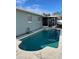 Kidney shaped pool with a concrete deck and screened enclosure at 4701 Lodestone Dr, Tampa, FL 33615