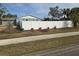 Side yard with gravel and a white fence at 4701 Lodestone Dr, Tampa, FL 33615