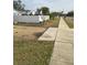 Side yard with gravel and a white fence at 4701 Lodestone Dr, Tampa, FL 33615