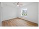 Bedroom with wood-look floors and a large window at 4829 Jenny Way, New Port Richey, FL 34652