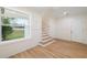 Light-filled entryway, showcasing a staircase and wood-look floors at 4829 Jenny Way, New Port Richey, FL 34652