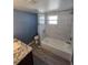 Bathroom with granite countertop and marble-tiled shower at 5052 Blue Heron Dr, New Port Richey, FL 34652