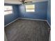 Bright bedroom with ceiling fan and grey wood-look tile floor at 5052 Blue Heron Dr, New Port Richey, FL 34652