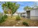 Spacious backyard with mature trees, screened porch, and storage shed at 5053 3Rd N Ave, St Petersburg, FL 33710