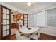 Charming breakfast nook with white table and chairs, adjacent to kitchen at 5053 3Rd N Ave, St Petersburg, FL 33710