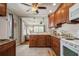 Open kitchen with wood cabinets, granite countertops and view of living room at 5053 3Rd N Ave, St Petersburg, FL 33710