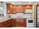 Bright kitchen with wood cabinets, granite countertops, and white appliances at 5053 3Rd N Ave, St Petersburg, FL 33710