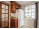 Kitchen features wood cabinets, white appliances, and a window overlooking the backyard at 5053 3Rd N Ave, St Petersburg, FL 33710