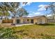 Exterior backyard view of home with sliding glass doors onto concrete patio at 5205 Landsman Ave, Tampa, FL 33625