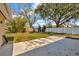 Spacious backyard with a concrete patio and a white fence under a blue sky at 5205 Landsman Ave, Tampa, FL 33625