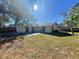 Sunny backyard with grassy area and patio at 5205 Landsman Ave, Tampa, FL 33625