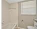 Updated bathroom with tiled shower and tub combination, along with a modern toilet at 5205 Landsman Ave, Tampa, FL 33625