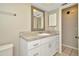 Bathroom featuring a vanity with granite countertop, mirror, and white cabinets at 5205 Landsman Ave, Tampa, FL 33625