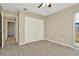 Neutral bedroom with a large closet, gray carpet, and a ceiling fan at 5205 Landsman Ave, Tampa, FL 33625