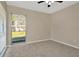 Bedroom featuring neutral colored walls and carpet, and a large window with blinds at 5205 Landsman Ave, Tampa, FL 33625