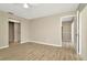 Bedroom with new floors, neutral walls, and a door leading into an attached bathroom at 5205 Landsman Ave, Tampa, FL 33625