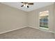 Bright bedroom featuring neutral colored walls and carpet, and large window with blinds at 5205 Landsman Ave, Tampa, FL 33625