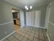 Simple dining area with tiled floor and sliding glass door to patio at 5205 Landsman Ave, Tampa, FL 33625