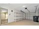 Attached garage with overhead door, installed shelving, and painted concrete floors at 5205 Landsman Ave, Tampa, FL 33625