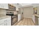 Well-equipped kitchen featuring stainless steel appliances, white cabinetry, and durable countertops at 5205 Landsman Ave, Tampa, FL 33625