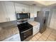 Modern kitchen with stainless steel appliances and granite countertops at 5205 Landsman Ave, Tampa, FL 33625