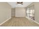 Spacious living room with wood floors, ceiling fan and a view of the outside through a large window at 5205 Landsman Ave, Tampa, FL 33625