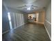 Living room with wood-look floors and access to the kitchen and patio at 5205 Landsman Ave, Tampa, FL 33625