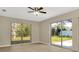 Bright living room with large windows and sliding glass door leading to a fenced backyard at 5205 Landsman Ave, Tampa, FL 33625