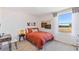 Cozy bedroom with terracotta bedding and large window at 5241 Salt Marsh Rd, Wimauma, FL 33598