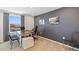 Modern home office with large desk and gray accent wall at 5246 Salt Marsh Rd, Wimauma, FL 33598