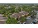 Aerial view of condo building near tennis courts and parking at 5557 Baywater Dr, Tampa, FL 33615