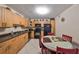 Kitchen with light wood cabinets, black appliances, and round dining table at 5557 Baywater Dr, Tampa, FL 33615