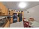 Kitchen with light wood cabinets, black appliances, and round dining table at 5557 Baywater Dr, Tampa, FL 33615