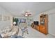 Living room with tiled floors, floral couch, and wood cabinet at 5557 Baywater Dr, Tampa, FL 33615