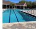 Community pool with lap lanes, lounge area, and brick pavers at 5557 Baywater Dr, Tampa, FL 33615