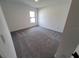 Bright bedroom featuring grey carpet and large window at 5710 Humkey St, North Port, FL 34291