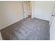 Spacious bedroom with grey carpet and ample natural light at 5710 Humkey St, North Port, FL 34291