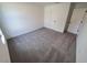 Simple bedroom with neutral carpet and doors at 5710 Humkey St, North Port, FL 34291