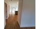 Bright hallway with wood-look tile flooring, leading to other rooms at 5710 Humkey St, North Port, FL 34291