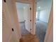 Hallway with light gray carpet and doors to bedrooms at 5710 Humkey St, North Port, FL 34291