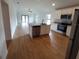 Modern kitchen with island, stainless steel appliances, and wood-look tile at 5710 Humkey St, North Port, FL 34291