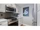 Kitchen with stainless steel appliances and herringbone backsplash at 629 Alhambra Rd # 604, Venice, FL 34285