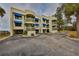 Two-story condo building with blue awnings and glass block accents at 6504 Surfside Blvd # 5, Apollo Beach, FL 33572