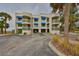 Two-story condo building with blue awnings and glass block accents at 6504 Surfside Blvd # 5, Apollo Beach, FL 33572