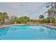 Inviting community pool with lounge chairs and lush landscaping at 6504 Surfside Blvd # 5, Apollo Beach, FL 33572