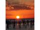 Silhouetted pier and sunset over the ocean at 6504 Surfside Blvd # 5, Apollo Beach, FL 33572