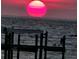 Stunning sunset over calm water with a pier in the foreground at 6504 Surfside Blvd # 5, Apollo Beach, FL 33572