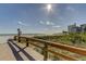 Wooden boardwalk leads to beach with volleyball net at 680 71St Ave # 14, St Pete Beach, FL 33706